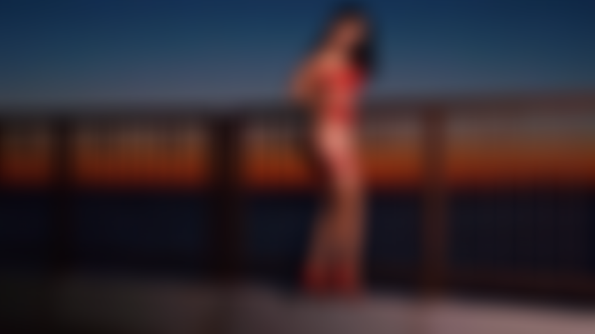Sensual topless tease at sunrise beach